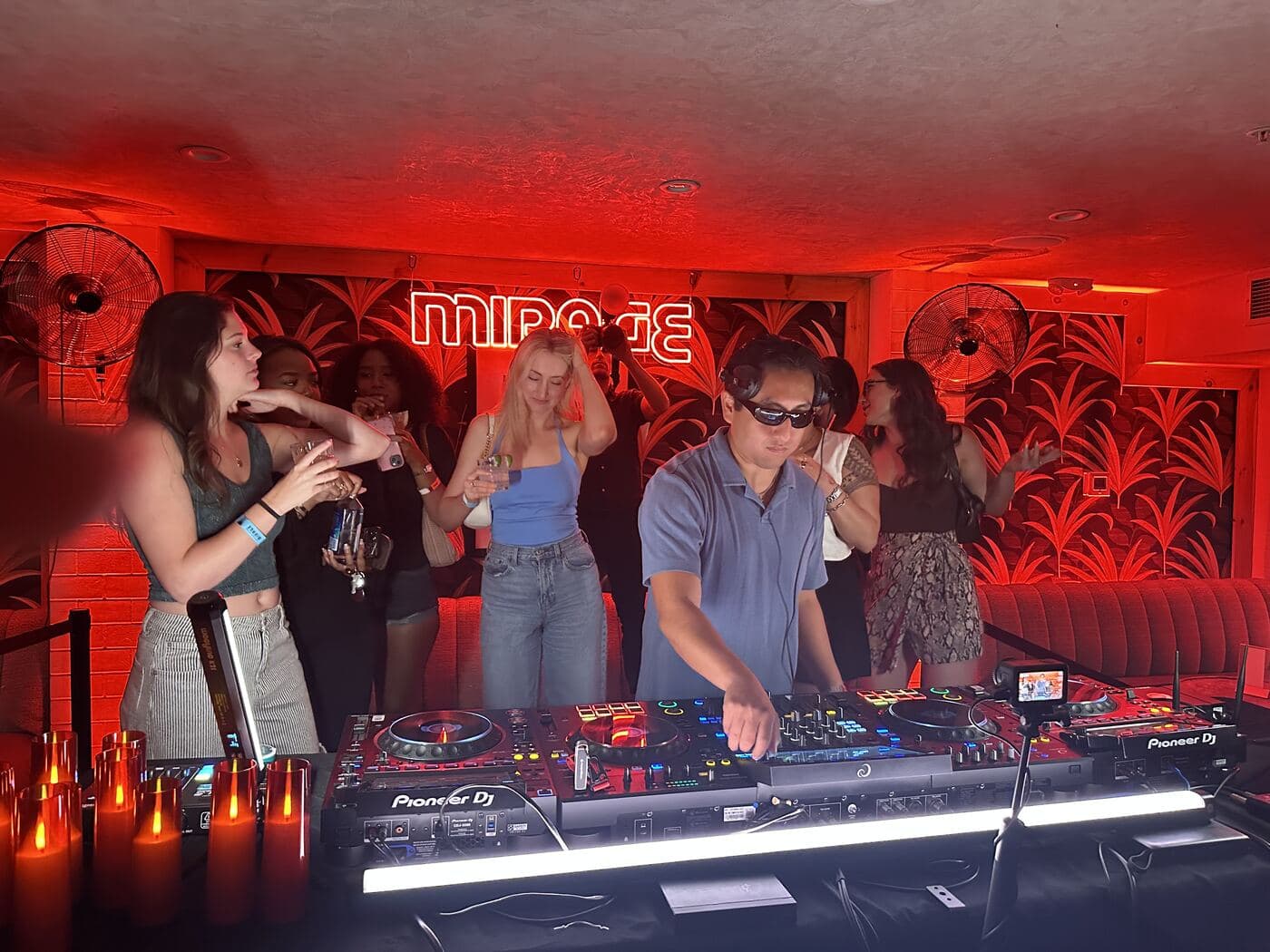 LP DJing solo in a warmly lit wood-paneled lounge