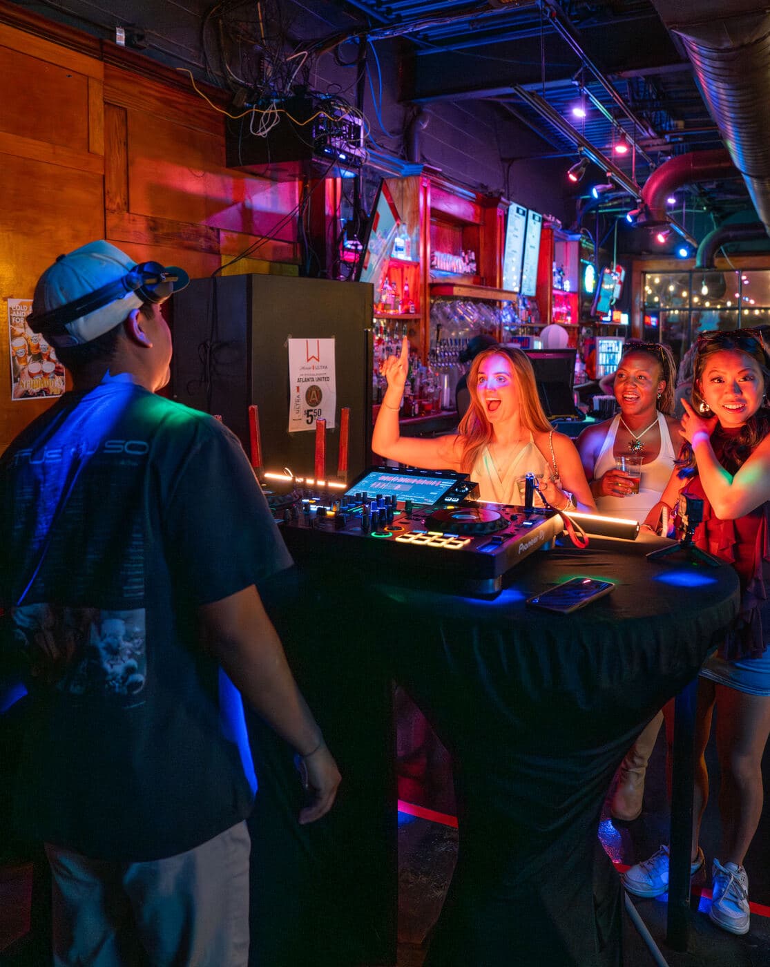 LP DJing at a small wood-paneled neighborhood bar